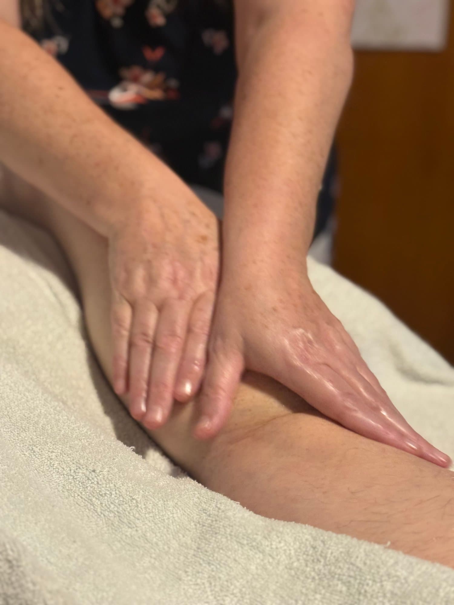 Nic providing hands-on full-body massage at her Riverside practice